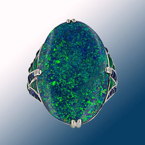 This large and lavish oval black opal with it's spectacular canvas of shimmering blues and greens is reminiscent of an Impressionist masterpiece by Monet. The opal, which we estimate to weigh between 14 and 15 carats (but appears much larger) is