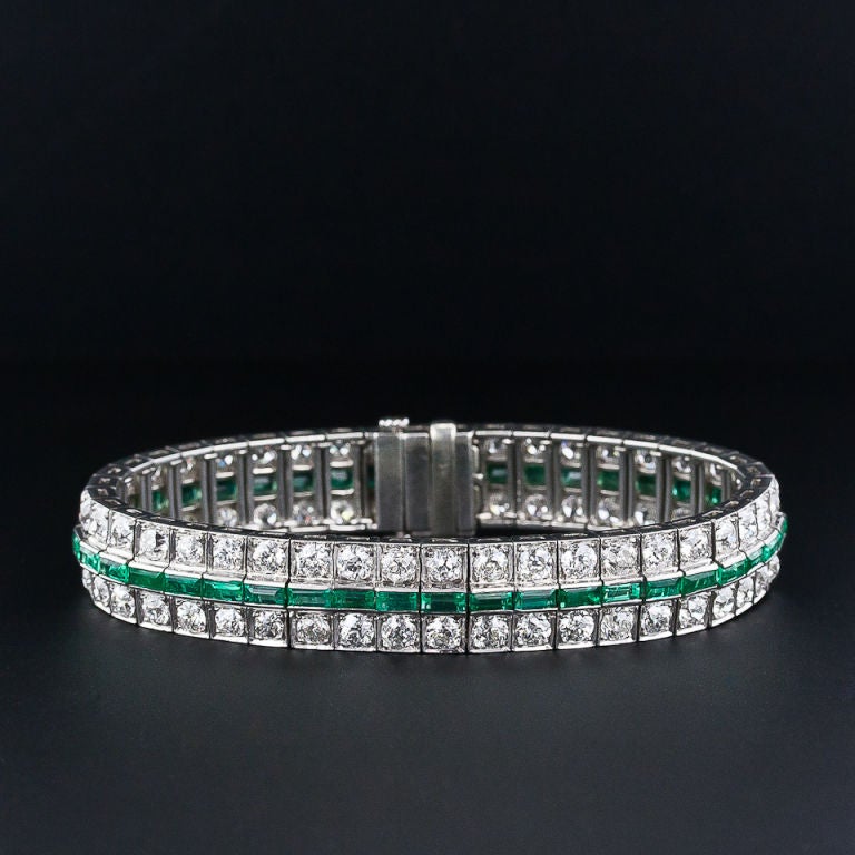 This classic 3-row bracelet from the 1920's is distinguished by its center row of bright and lively crystal green emeralds from the renowned Chivor emerald mines of Columbia. The outside rows are composed of 15 carats of scintillating old-mine cut