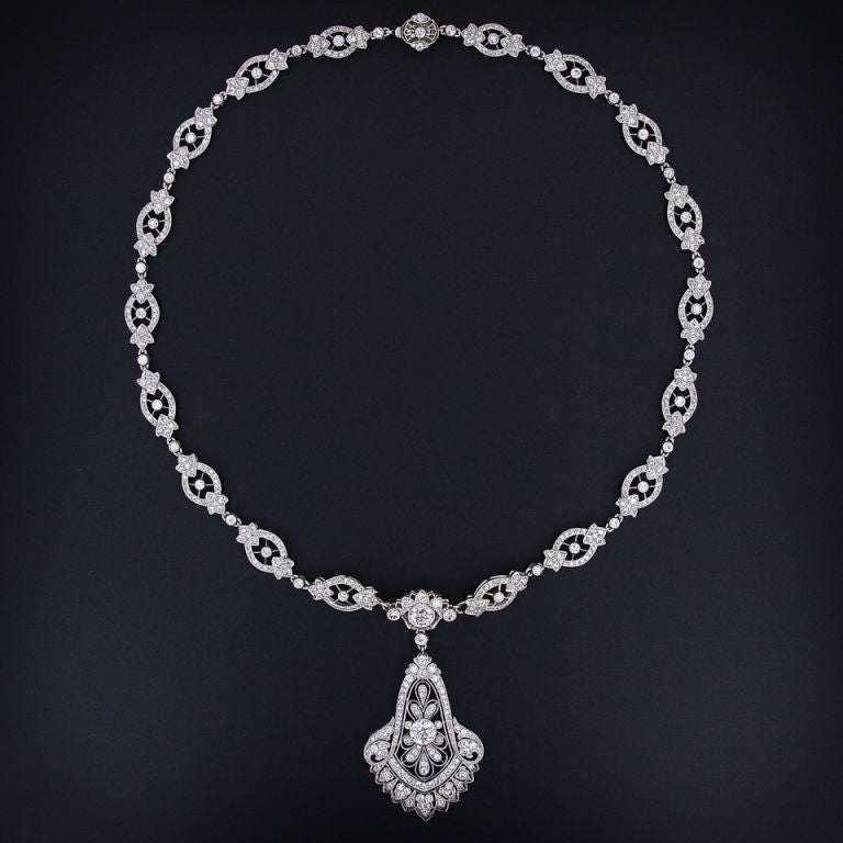 An absolutely stunning transitional style - late Edwardian / early Art Deco - platinum and diamond necklace signed Cartier. This magnificent treasure is accompanied by Cartier's original bill of sale from New York - dated January 18, 1929 - the