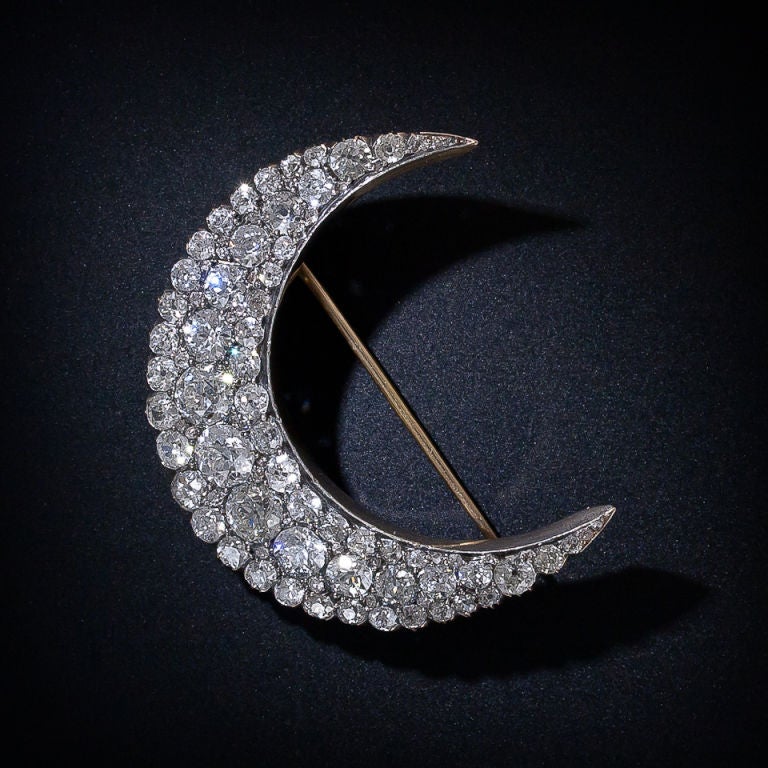 Over 11 carats of bright-white, jam-packed diamond sparklers light up the sky in this late 19th century crescent brooch measuring a whopping 1 7/8 inches across! A magnificent, glistening lunar bauble crafted in silver over 14 karat yellow gold. A