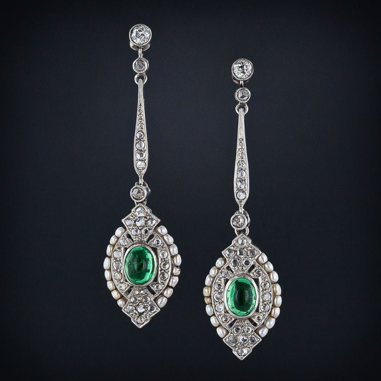 Delightful and delicate platinum ear drops highlighting rich green glowing cabochon emeralds embellished with an array of twinkling rose-cut diamonds and natural seed pearl borders. Simply lovely.<br />
<br />
Inventory No. 20-1-2298