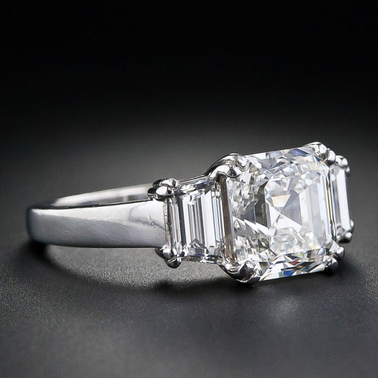 A 3.20 carat high quality Asscher cut diamond is set in a tailored, classic platinum mounting. The diamond, which is accompanied by a GIA certificate which states G color, VS2 clarity, is set with four split prongs and flanked by perfectly match