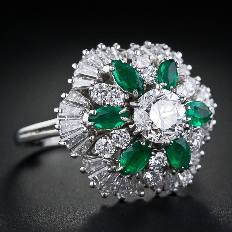 This sparkling ballerina features a bright white round brilliant-cut diamond, weighing just over 1 carat, dazzling atop an undulating skirt of pirouetting marquise-cut emeralds, round brilliant and tapered baguette-cut diamonds. An impressive,