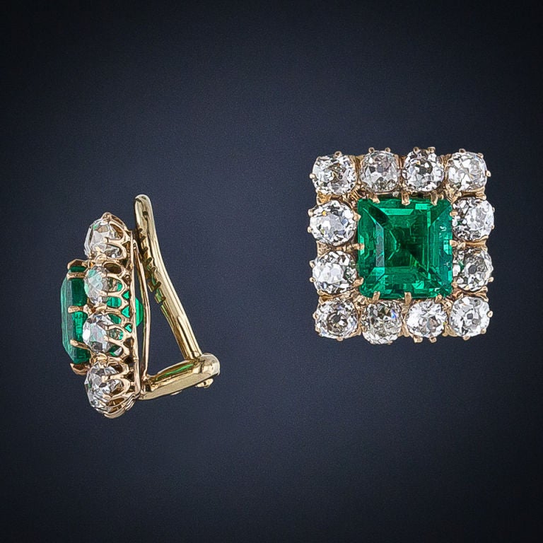 A pair of vivid crystalline green old-mine Colombian emeralds weighing just under 4.00 carats total weight (2.04 and 1.79 carats, respectively) radiate from the centers of sparkling diamond frames in these classic Victorian earrings, circa 1890. The