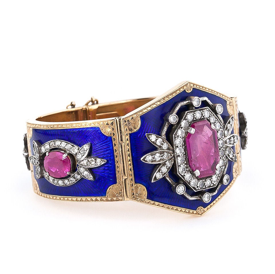 Stunning Victorian 14K rose gold and silver cuff bracelet featuring five cobalt blue enameled plaques each centered with a beautiful ruby (5 total, 16.00 carats total weight) wrapped with a pretty diamond (5.00 carats total weight, H-J color, SI