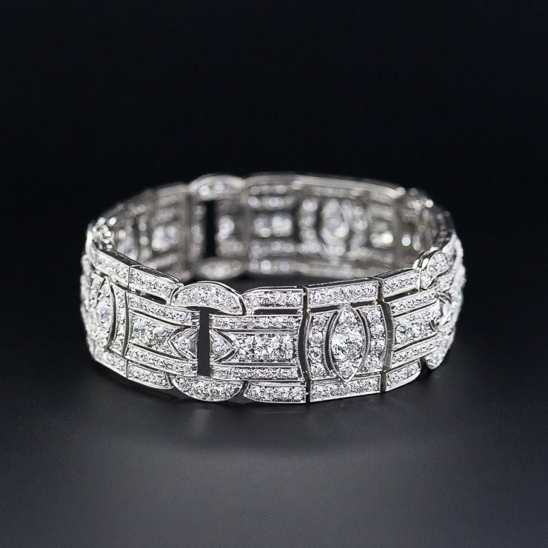 This dynamic and dazzling 11/16 inch-wide original Art Deco diamond bracelet, circa 1925, is packed with bright white, sparkling European-cut diamonds totaling 13.00 carats. The weighty platinum mounting, essentially fashioned from five diamond