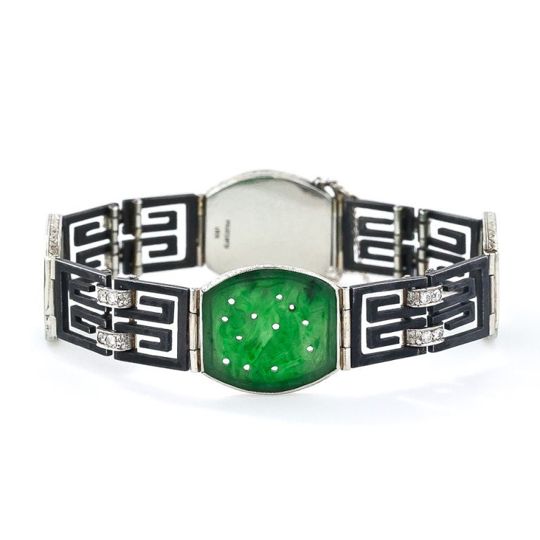 An enchanting, exotic and rare vintage bracelet from the highly individualistic and exceptional San Francisco jeweler Marsh & Company. Rendered in the Marsh & Co. trademark blackened steel and 18k white gold, four translucent green jade plaques