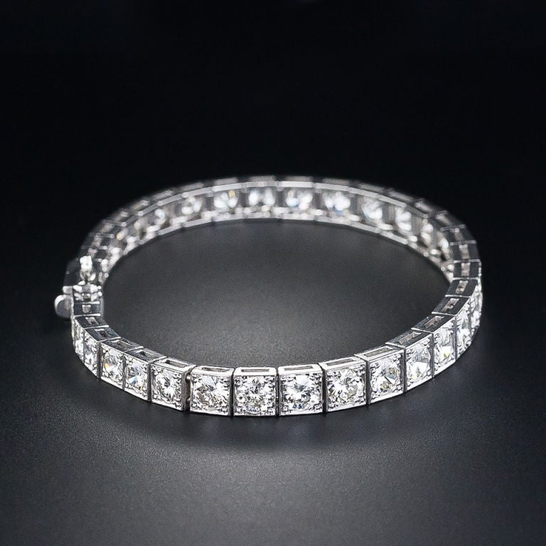 Judging from the cuts of the diamonds, this bright and brilliant, classic, straight row bracelet, containing 11.00 carats bright white sparkle, was produced in the 1950s. This vintage beauty exhibits a subtle gradation ranging from .50 carat round