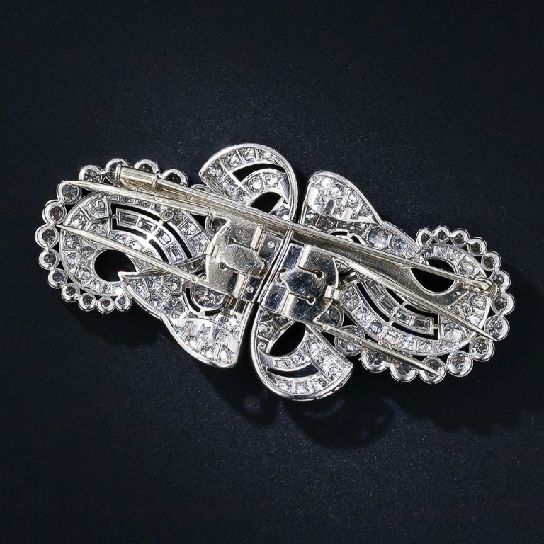A double cornucopia crafted in platinum and packed to the hilt with bright white and sparkling European-cut diamonds with a smattering of baguettes. The flowing multi-dimensional design is equally effective when separated into double clips or