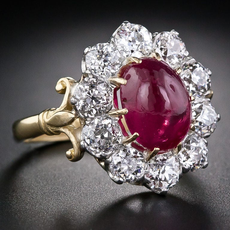 This alluring and extra-lovely Victorian floral motif ring centers on a luscious red, oval,unheated Burmese Ruby weighing approximately 5.00 carats and accompanied by a certificate from the American Gemological Laboratory). The gemmy  ruby glows
