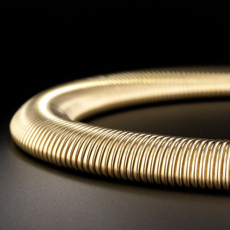 Sometimes referred to as 'gaspipe' style, these flexible, slinky, semi-expandable necklaces (and bracelets) were prominent in the 1940s wartime years and, along with many other industrial styled Retro jewelry, are said to be modeled after the