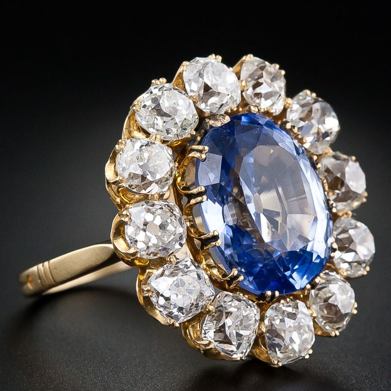 This fabulous, lavish and large scale (one-inch by 7/8 inch!) late-nineteenth century sapphire ring features a faceted oval 10.00 carat sapphire, of old Ceylon origin, with a bright and shining medium-light blue color. The sapphire is surrounded by