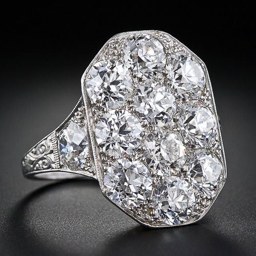 Sunglasses are recommended when viewing this ultra-sparkling sensation! Twelve bright white high-caliber European-cut diamonds rub shoulders to a blinding effect in this truly extraordinary, all original Art Deco platinum diamond dinner ring, circa
