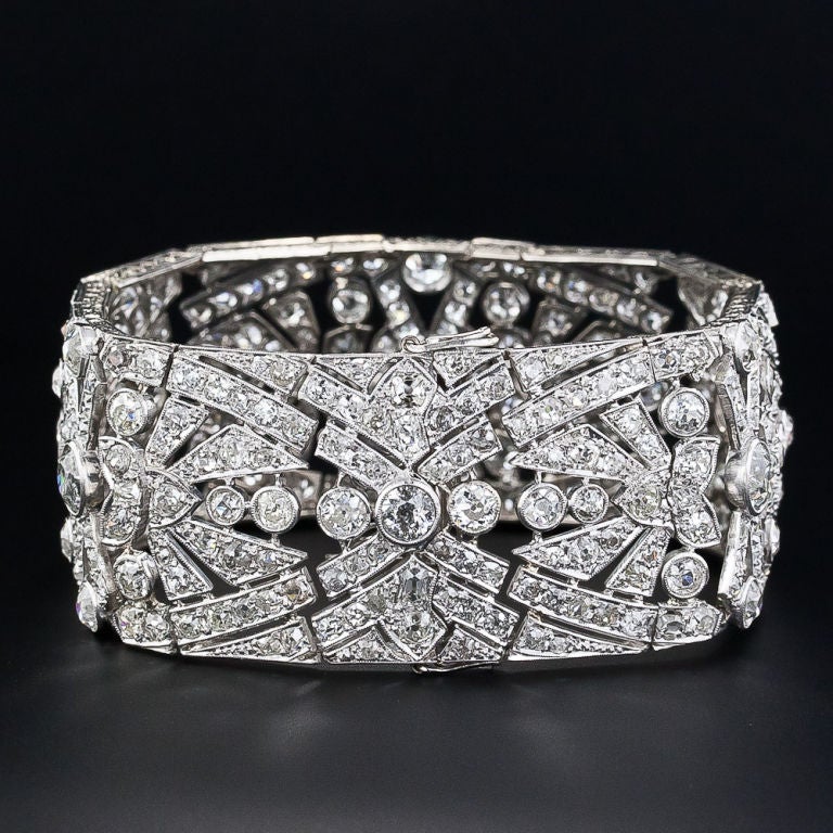 This dynamic Art Deco dazzler comes straight from the decadent roaring 20s. 38 carats (thirty-eight carats!) of old-mine cut and European-cut diamonds are artfully arrayed over a 1 1/8 inch wide, 7 1/4 inch long geometrical design which ideally