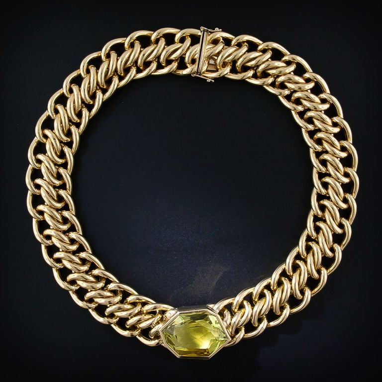 Designed by Paloma Picasso for Tiffany & Co. - a bold and beautiful gold necklace highlighting a 50 carat asymmetrical vivid lemon-lime green Citrine. This unusual and unusually beautiful stone is embraced by an angular geometric bezel-setting which