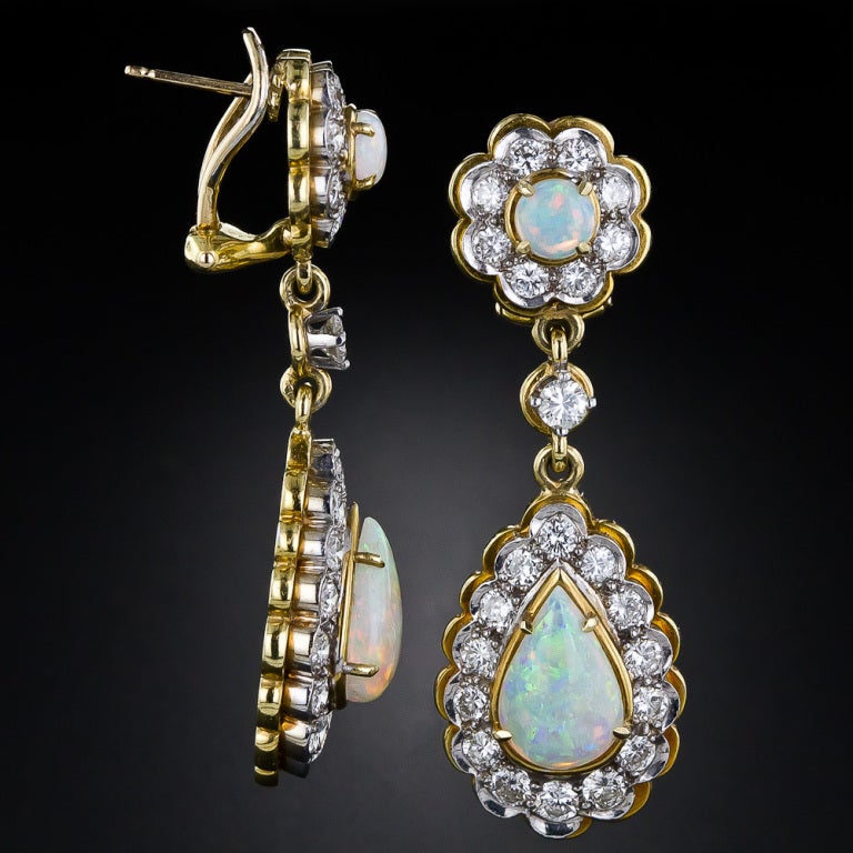 Two matched pairs of glowing white opals, displaying a wide spectrum of bright pastel colors, provide the center of attention in these gorgeous drop earrings, crafted in two-tone yellow and white gold and sparkling with 2.50 carats of bright-white