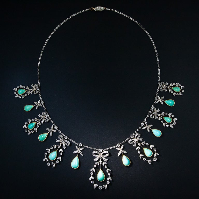 An absolutely ravishing (and rare) turquoise and diamond necklace crafted during the late-nineteenth/early-twentieth century. This original Belle Epoque (or Edwardian) jewel is comprised of seven pear-shaped turquoise drops, each of which swings