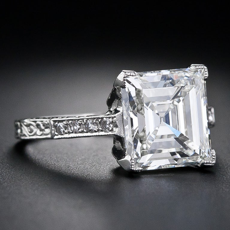 This astonishingly beautiful, original Edwardian diamond ring, circa 1910, gleams with a gorgeous square step-cut, or emerald-cut, diamond (without cut corners), accompanied by a GIA - Gemological Institute of America grading report stating: J color