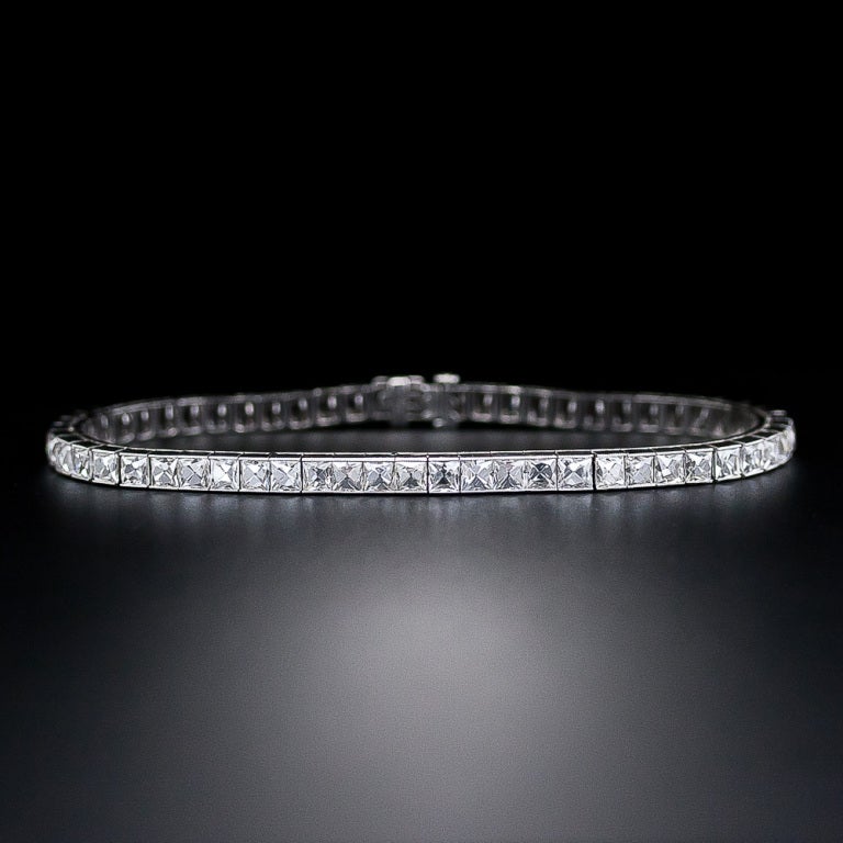 This enchanting and eminently wearable Art Deco diamond dazzler, c.1920s, is composed of fifty-nine bright white gorgeous and glistening French-cut diamonds - together weighing a total of 14.00 carats. The diamonds are snugly and seamlessly situated