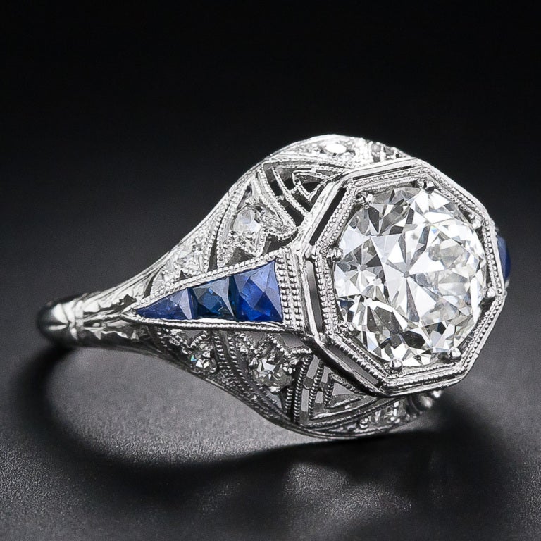 This dynamic and dazzling, original Art Deco diamond ring, circa 1920s, shines front and center with a big, bright and sparkling European-cut diamond - weighing 1.87 carats. The beautiful diamond is set in a double-tiered and double-milgrained