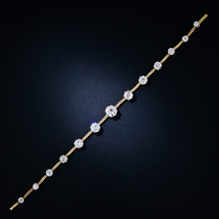 7.75 carats of gorgeous old European-cut diamonds, featuring a high-quality 1.60 carat diamond in the center, sparkle loud and clear from the front half of this exquisite antique choker necklace, which, with the pressing of a couple small clasps,