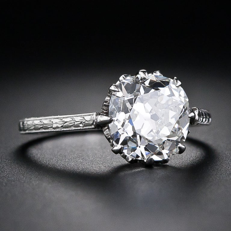 This gorgeous Edwardian-era solitaire diamond engagement ring, circa 1915, elegantly presents a 2.90 carat antique cushion-cut diamond, accompanied by an EGL - European Gemological Laboratory certificate stating: H color - VS2 clarity, however, we