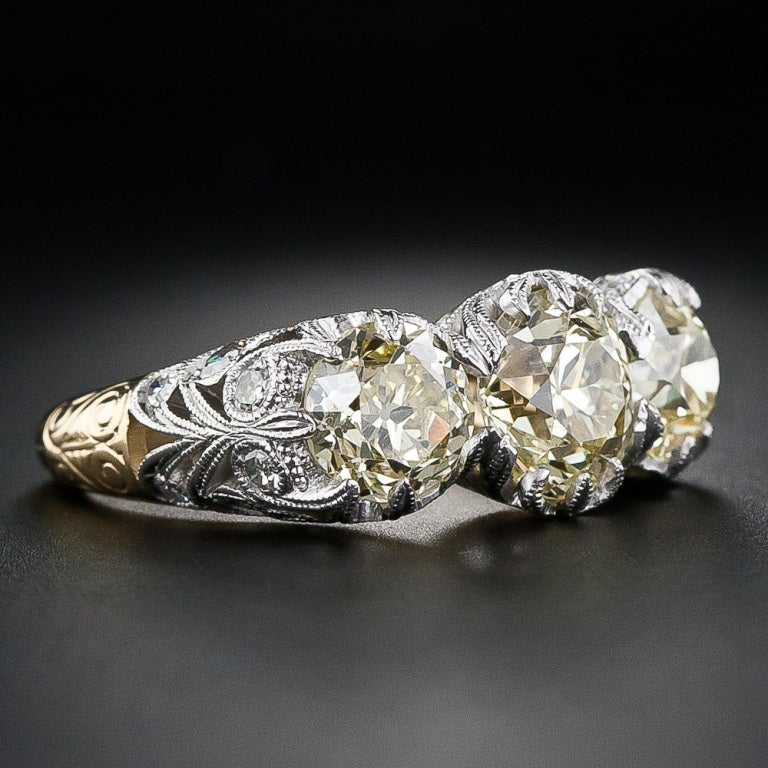 A harmonious trio of natural yellow European-cut diamonds - together weighing 3.70 carats - glisten and glow shoulder-to-shoulder in this newly created platinum and 18 karat yellow gold Edwardian-style mounting which we have faithfully copied from