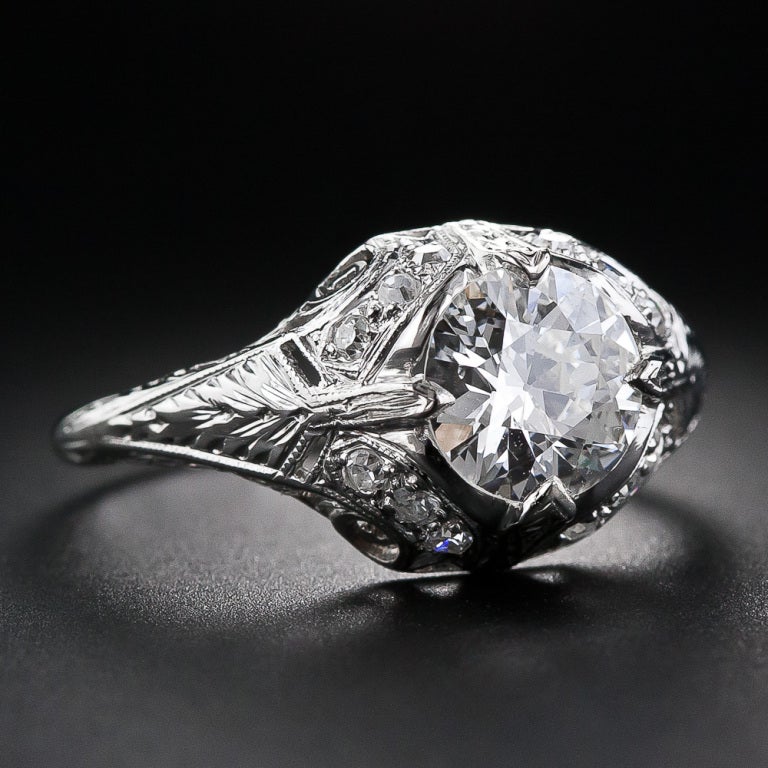 A gorgeous, bright-white and brilliant European-cut diamond, clocking in just two points shy of a carat-and-a-half, is majestically presented in a superb and stunning early-Art Deco platinum mounting imbued with sophisticated neo-classical design