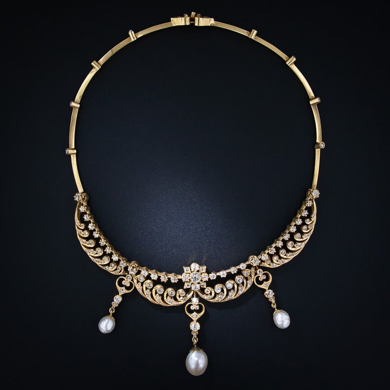 A magnificent and majestic nineteenth-century diamond and pearl necklace, rendered in radiant 18 karat yellow gold, more than likely of French origin. Four main collar sections are designed with a kinetic wave motif composed of glittering rose-cut