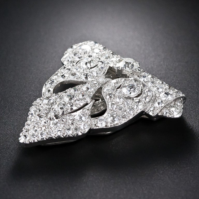 A dynamic and dazzling pair of platinum and diamond clips from the zenith of the Art Deco period - circa 1925. These elegantly and exotically fashioned jewels sparkle to the max with 8 carats of tightly pave' (from Middle French pavé 