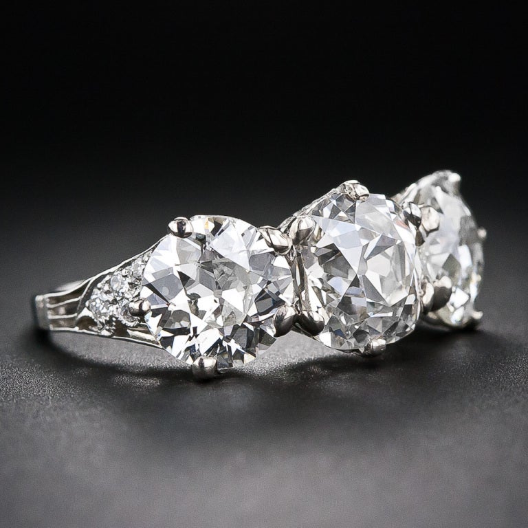 This sublime ring was hand-crafted in platinum by Tiffany & Co. - circa 1910 - by America's most prestigious jeweler. Featuring a dazzling 2.33 carat mine-cut diamond center with a vibrant 1.40 carat European-cut diamond neighbor on each side (over