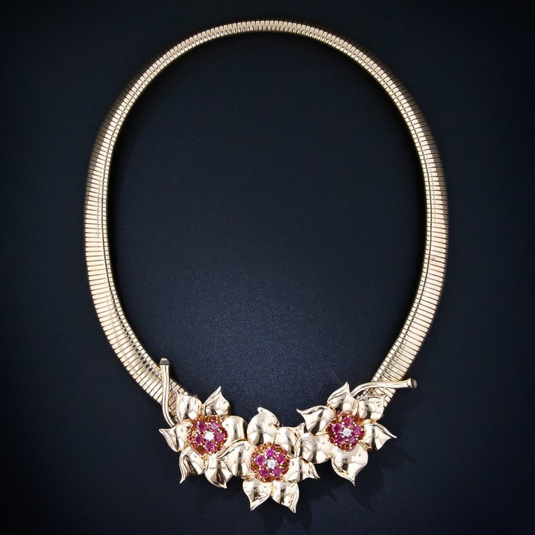 A trio of beautiful bright red Burma ruby and diamond centered flowers comprise the center of attention of this rare and wonderful 1940s vintage necklace by America's most heralded jeweler - Tiffany & Company. The three flowers, which also serve as