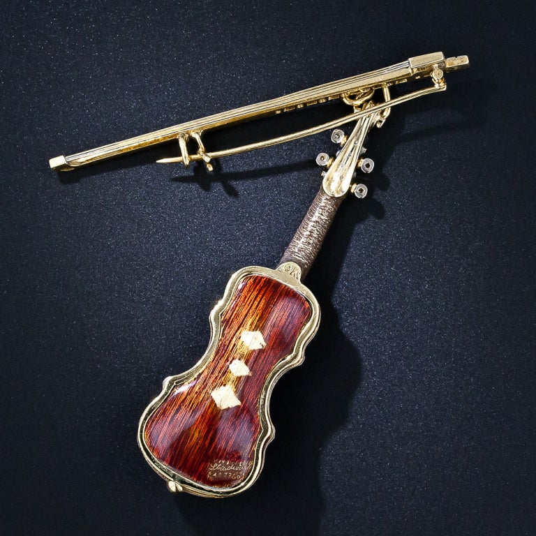 Music for your eyes! A piccolo Stradivarius violin c.1760 is realistically rendered in three dimensions with golden strings, a sparkling diamond outer binding, fingerboard, tuning keys and bow. The reddish-brown enamel nicely emulates the spruce