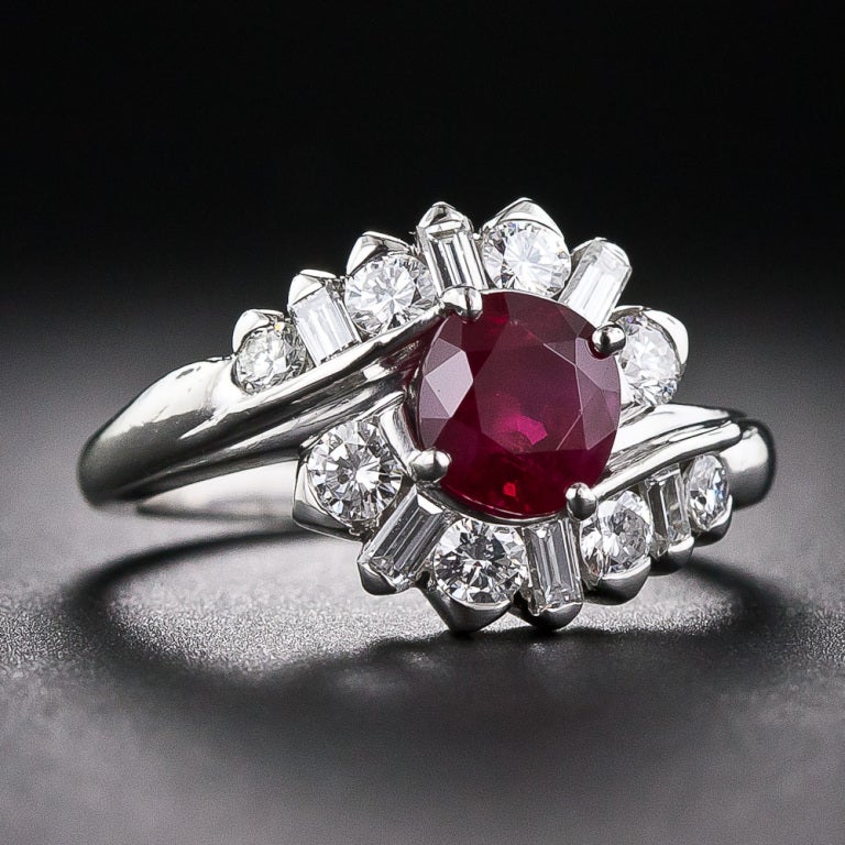 In this stunning ring a swirl of bright and dazzling round and baguette diamonds embrace the star of the show: a ravishing 1.24 carat deep-red ruby with an AGL report stating it has not been heat treated and is of Burmese origin. Beautifully