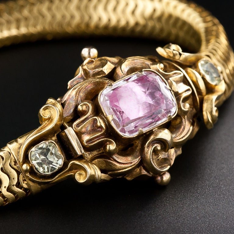 This rare and resplendent Georgian bracelet from the 1840s is a collector's dream. The centerpiece of the bracelet (which also conceals its clasp) has simply masterful scrolling leaf and flower gold repousse work, and features a shimmering