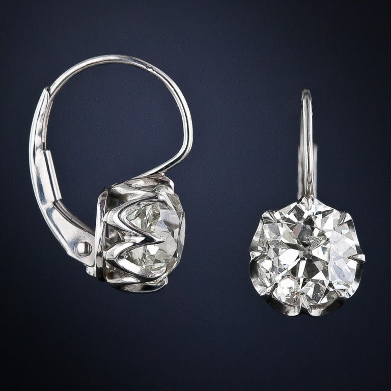 The effortlessly elegant way to wear a pair of rare antique old-mine cushion-cut diamonds. A tantalizing 3.23 carats (1.60 and 1.63 carats respectively), set in crisp and delicate platinum, in coronet settings with secure European-style leverbacks.