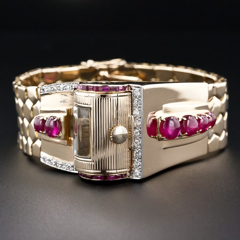 Retro jewels don't come much cooler than this remarkable timepiece and bracelet combo from the fabulous forties. A fluted cylinder at the crest of the ruby and diamond-studded wave design revolves 180 degrees to reveal the time of day or night. The