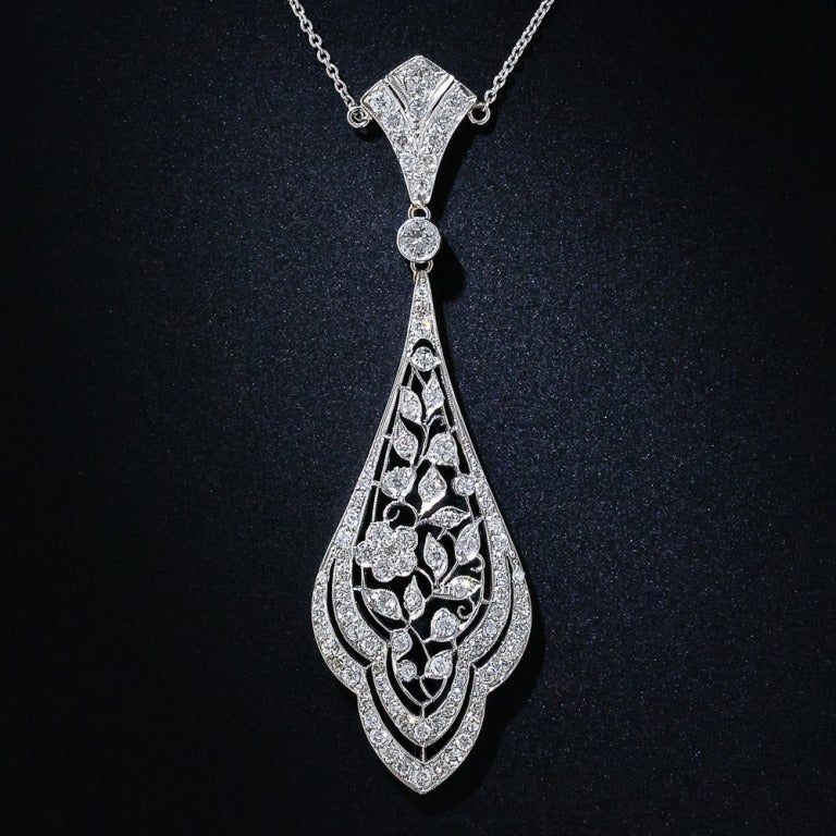 This alluring - circa 1910 - pendant necklace is a breathtaking blend of early Art Deco design elements and the divine couture lace of the Edwardian platinumsmiths. Nearly two carats of bright-white, dazzling diamonds highlight beautifully wrought
