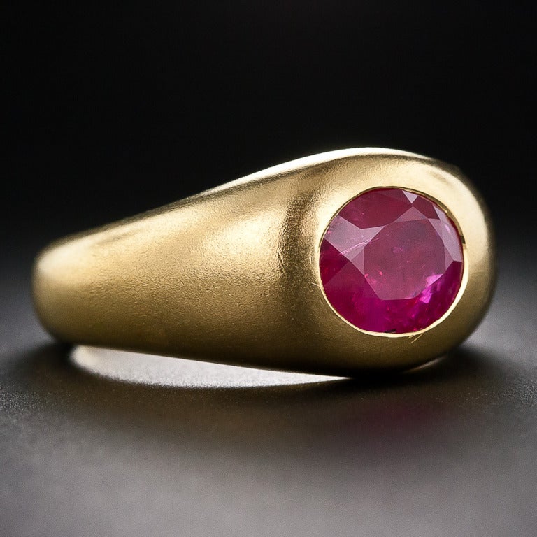 A richly saturated Burmese Ruby, weighing 3.37 carats and designated natural - no heat by the American Gemological Laboratory (AGL), speaks for itself in this classic gypsy style ring crafted in weighty, rarely seen, 21 karat (900) yellow gold