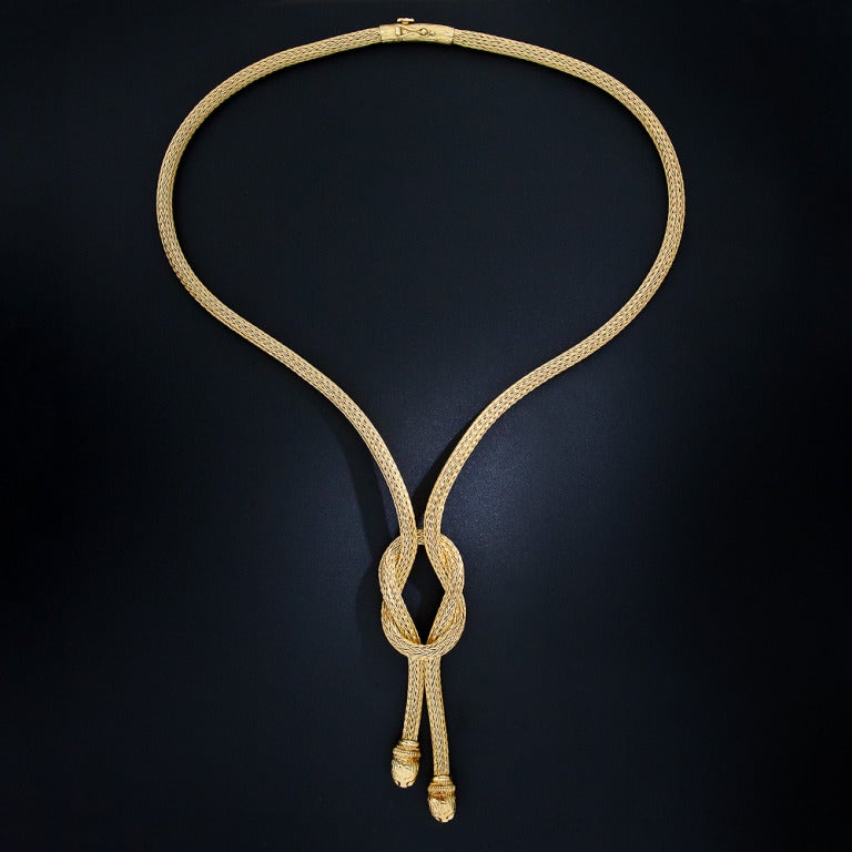 A fabulous necklace and bracelet suite by the renowned and extraordinary Athenian jeweler - Lalaounis. Composed of finely woven 18 karat yellow gold ropes, the 26 inch-long lariat style necklace is capped with a pair of friendly mythological beasts.