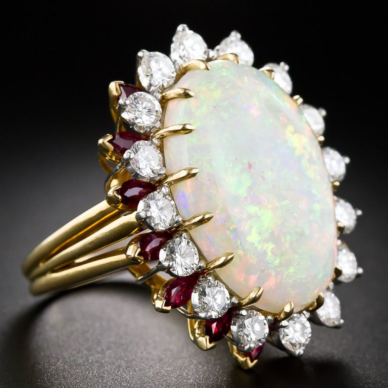 A big beautiful confetti colored bauble by one of America's premier high-end jewelry manufacturers - Hammerman Brothers of NY, NY. A gorgeous 14.00 carat opal, displaying a multi-chromatic palette of glowing pastel colors, is framed with 2.00 carats