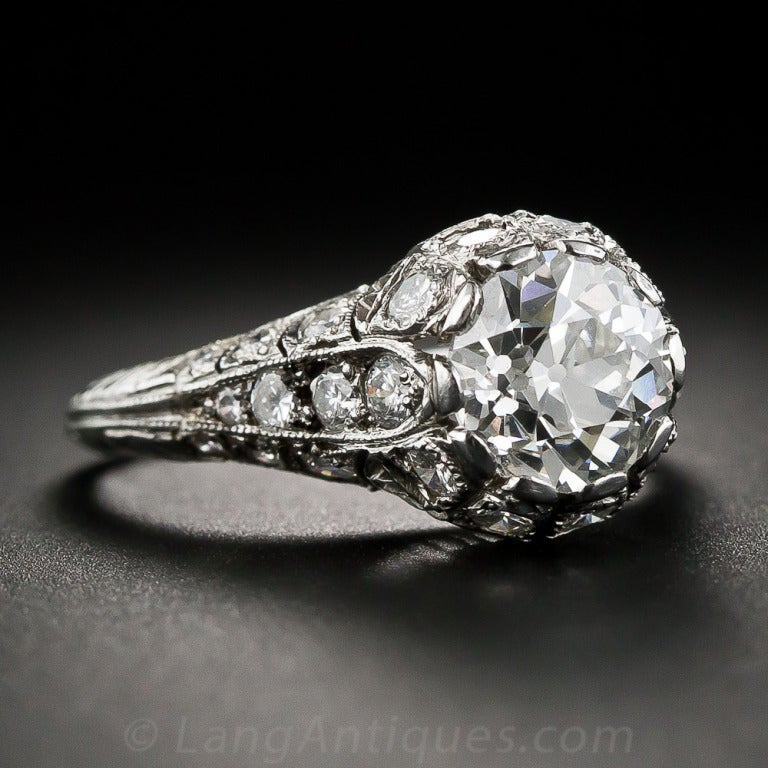 Absolutely captivating, the central European-cut diamond stands proud in this highly detailed, masterfully rendered platinum and diamond setting. To tell the truth, we refer to the setting as Edwardian 'style' only due to the high-quality, full-cut