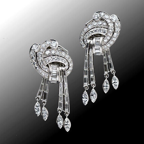 These glamorous and sexy articulated diamond drop earrings from the 1950s jiggle and dance with every movement as streams of baguette and marquise diamond tassels cascade from graceful diamond swirls.

Inventory No. 20-91-2033