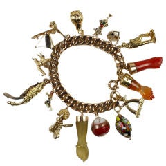 A gem-set, paste, glass, enamel, 18 karat gold charm bracelet