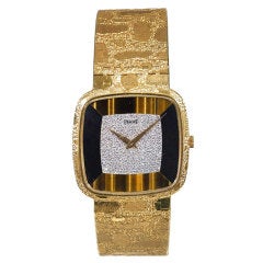 Vintage PIAGET Yellow Gold, diamond, onyx and tiger's eye bracelet watch