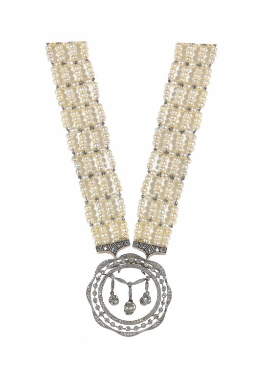 PLEASE NOTE: OUR PRICE IS FULLY INCLUSIVE OF SHIPPING, IMPORTATION TAXES & DUTIES

Of circular outline, the detachable openwork pendant designed as garlands of rose-cut diamonds, each suspending a fringe of collet-set old European-cut diamonds,