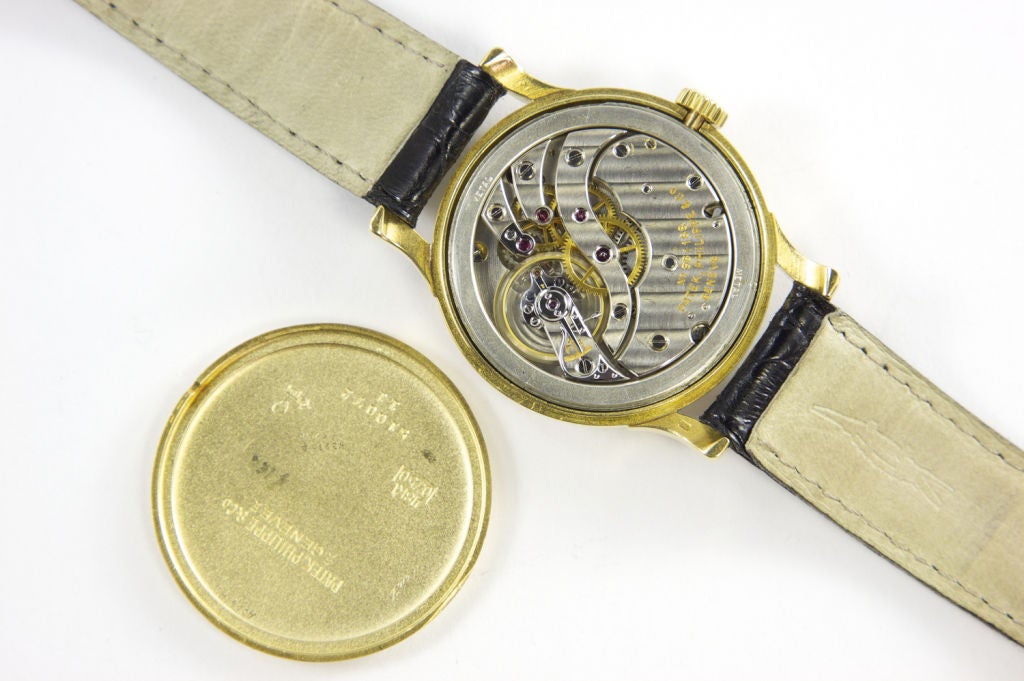 Patek Philippe & Cie, Genève. Ref. 1596. Produced 1947 and sold April 2nd 1948. Accompanied by the Extract from Archives. Fine and rare, 18K yellow gold gentleman's.<br />
C. three-body, solid, polished, overhanging lugs, rounded band. D. Matte