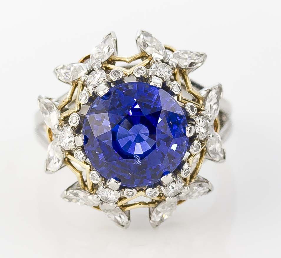 Rare and unusual bee motif cocktail ring with a sapphire central stone, by Jean Schlumberger for Tiffany & Co., circa 1970s. The ring features platinum setting with 18K gold accents and the design is of 6 diamond encrusted bees forming a crown