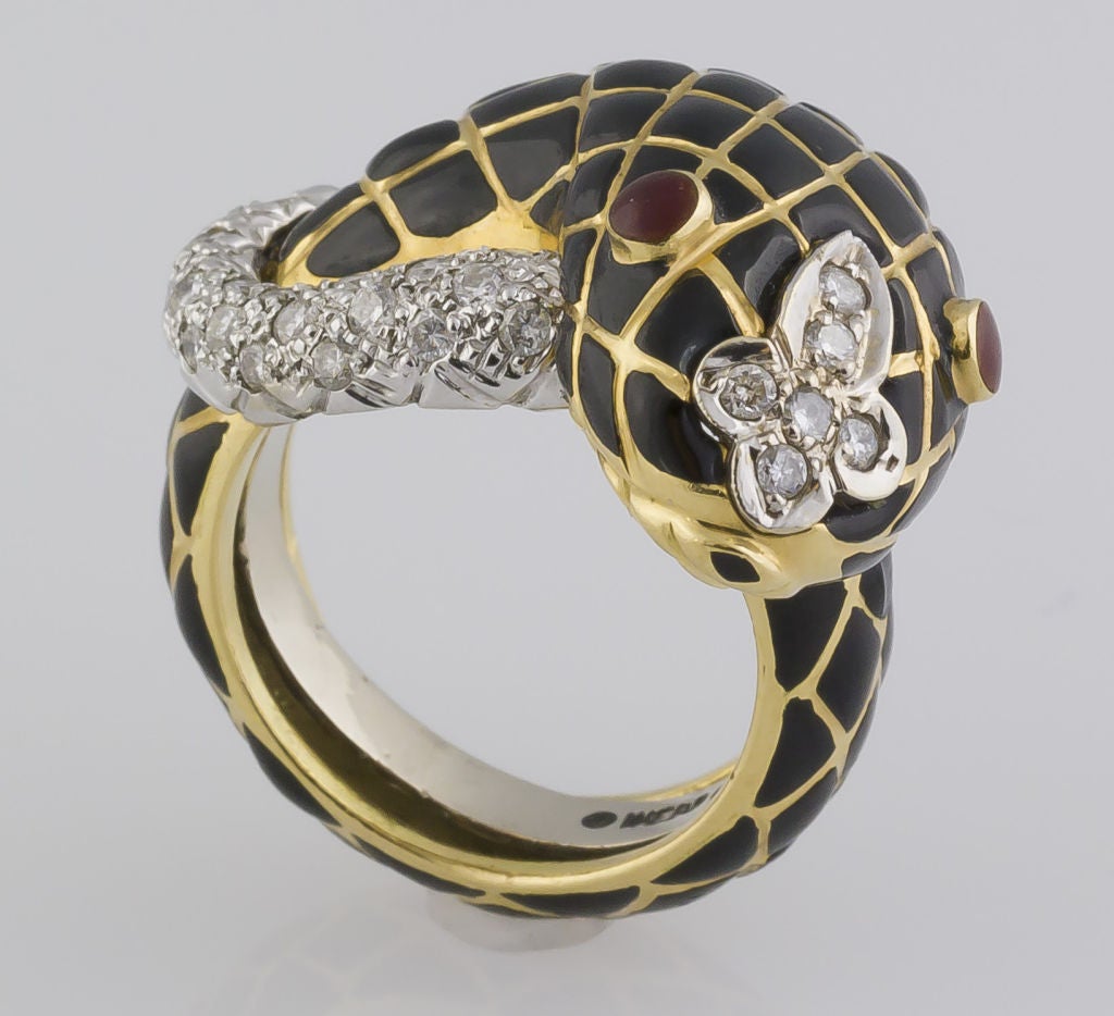 Intricate and unusual 18K gold, diamond, enamel and platinum ring by David Webb. It features the likeness of a rattlesnake, with black enamel body, red enamel eyes and pave set in platinum with high quality round cut diamonds comprising the