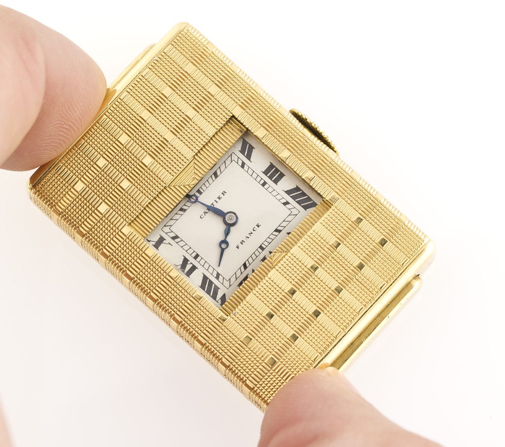 Very rare and unusual 18K yellow gold traveling clock with a push button 